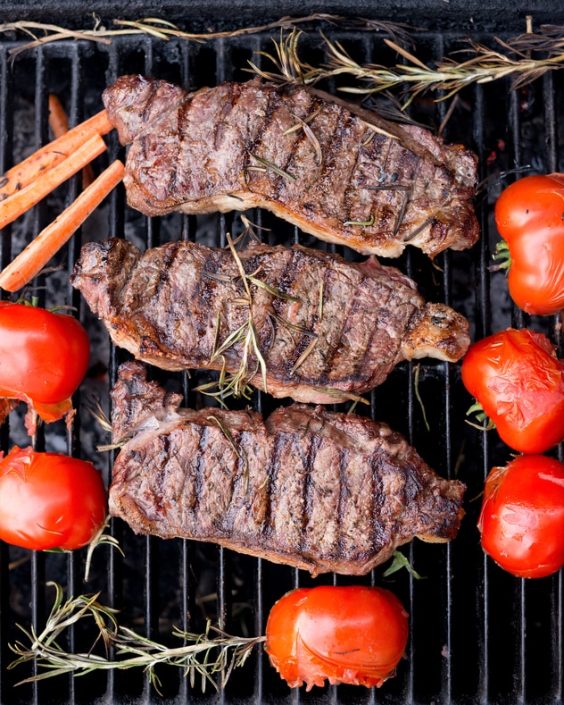 steaks on the grill with vegetables